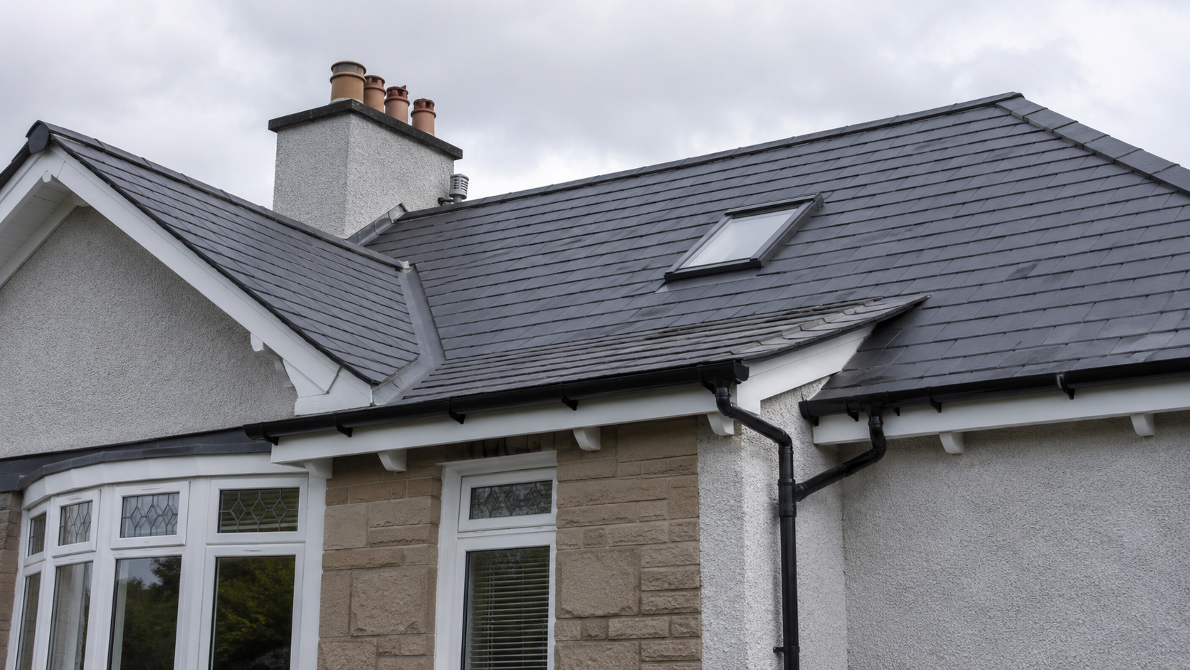 Clean slate roof with skylight and gutters